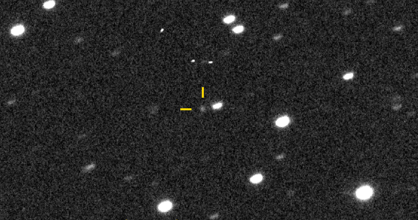 The interstellar object 3I/ATLAS appears as a clear but faint dot in the middle of this monochrome image, surrounded by slightly streaked stars.