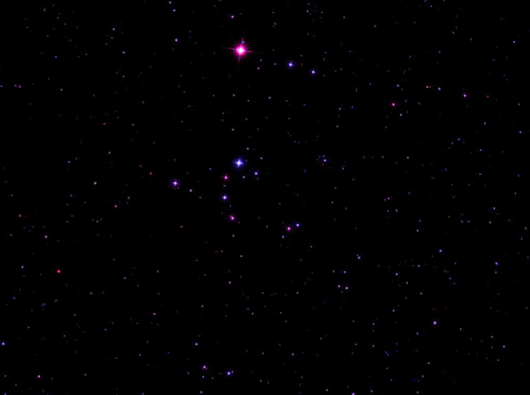 The Broken Engagement Ring asterism, a semicircle of stars of varying brightness and color, set against the dark night sky near the star Merak in Ursa Major.